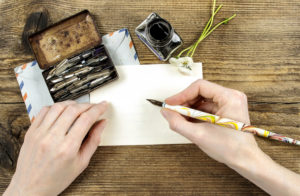 girl writing a letter with ink pen